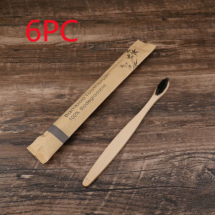 Bamboo toothbrush with packaging on a wooden surface, labeled as 6-pack.