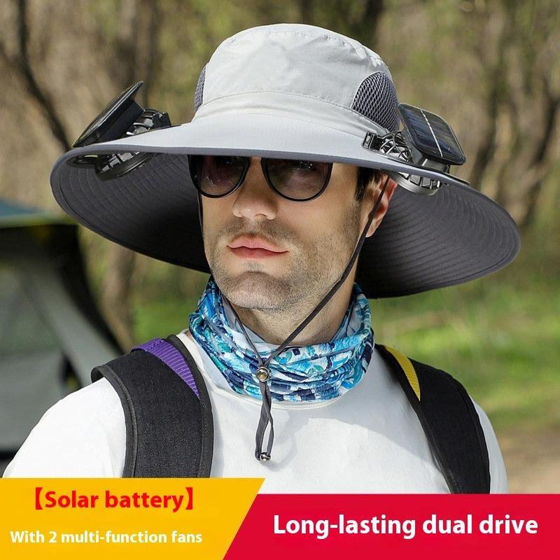 Person wearing a large sun hat with solar battery and fans, outdoors.