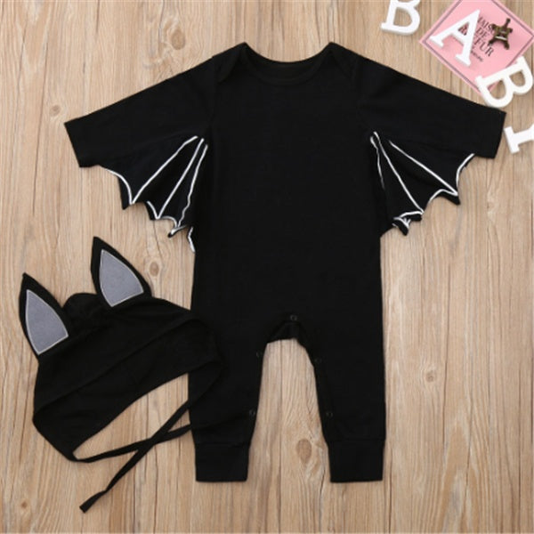 Black baby romper with bat wings and ears on a wooden surface