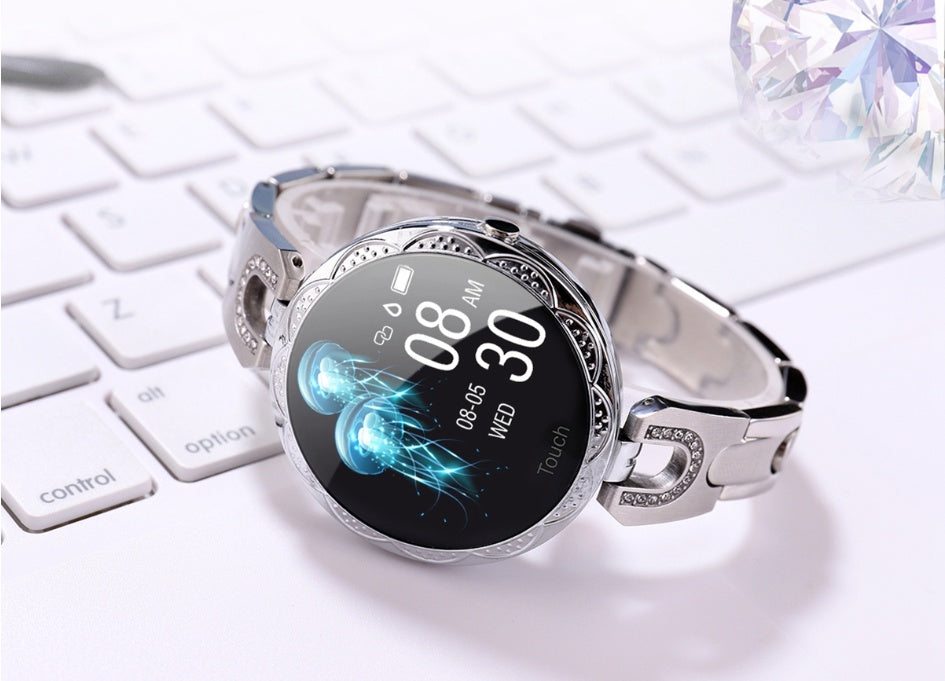 Silver smartwatch with a digital display on a white surface