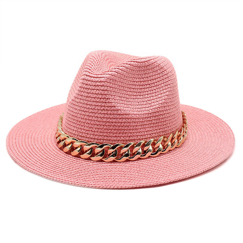 Pink straw hat with a gold chain band on a white background