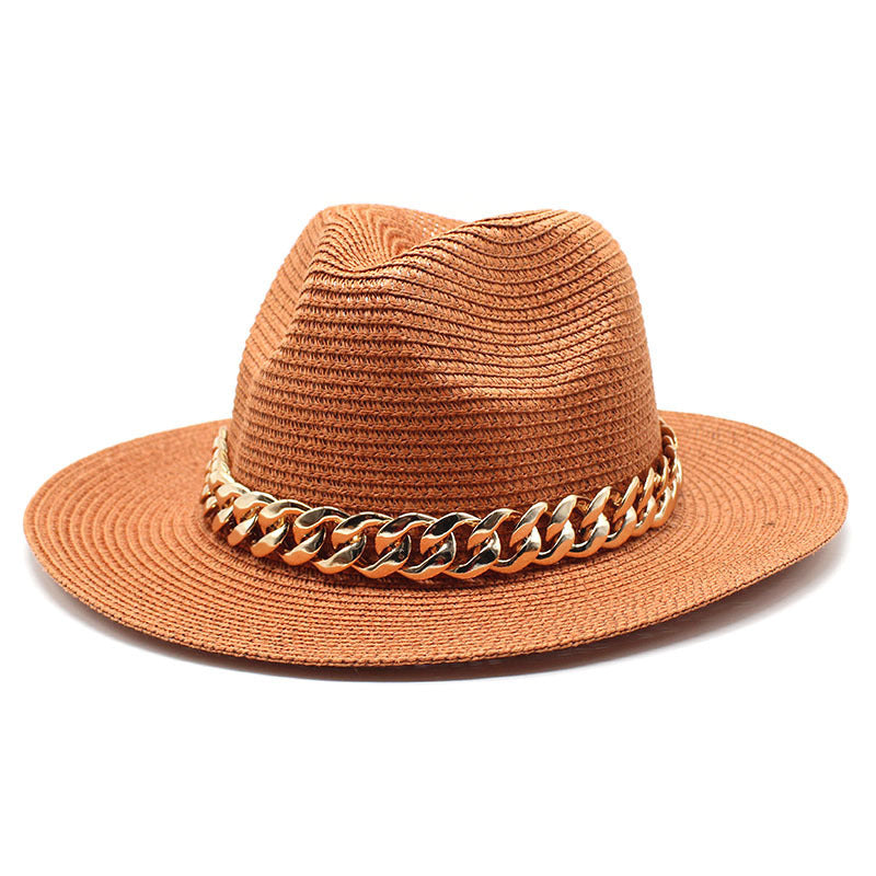 Brown straw hat with a gold chain band on a white background