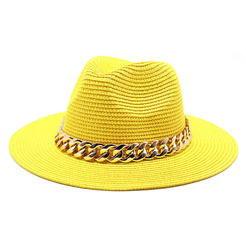 Yellow straw hat with a gold chain band on a white background