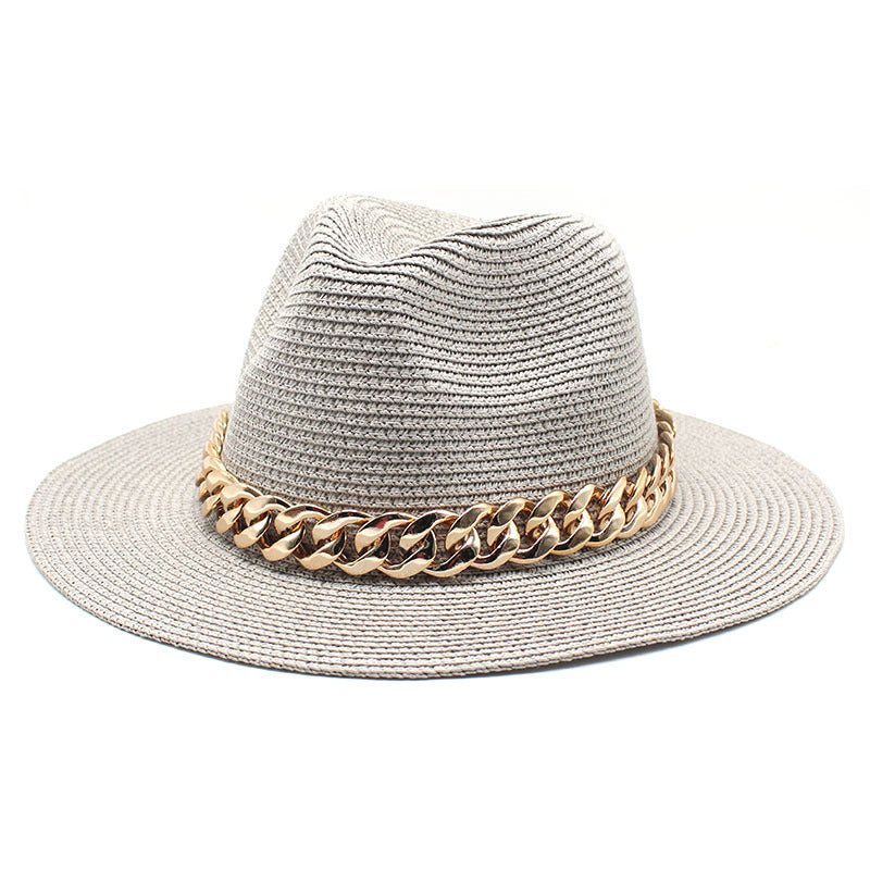 Gray straw hat with a gold chain band on a white background