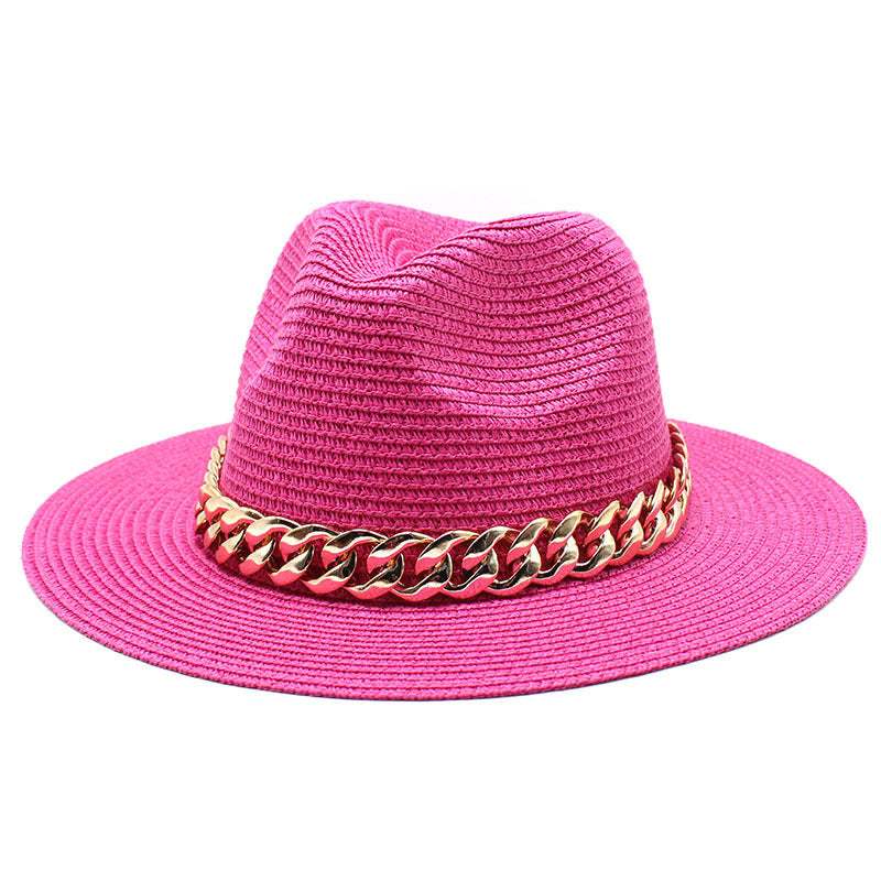 Pink straw hat with a gold chain band on a white background