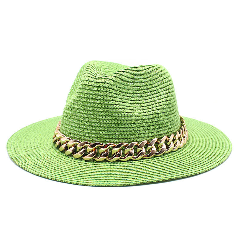 Green straw hat with a gold chain band on a white background
