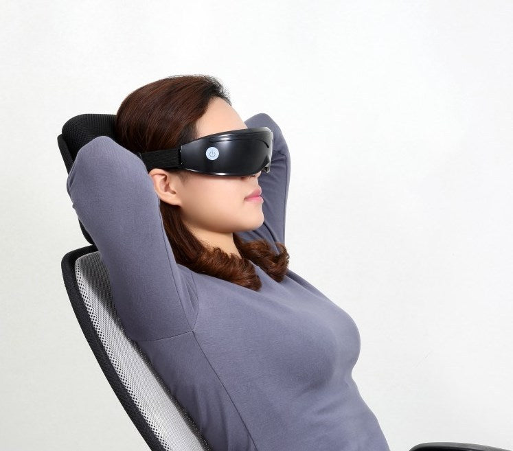 Woman using a massage chair with a neck and shoulder massager on a white background