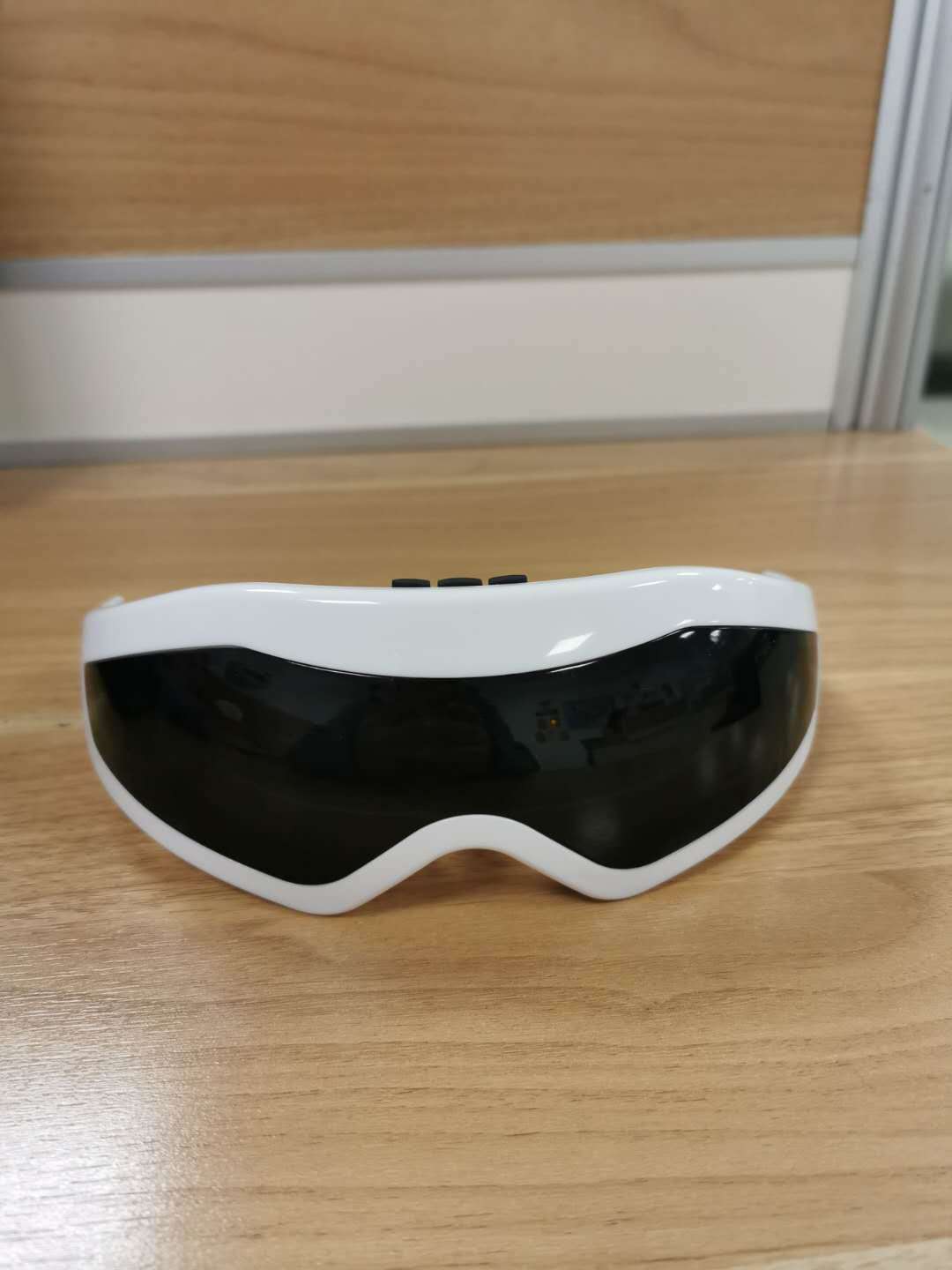 White and black eye mask on a wooden surface