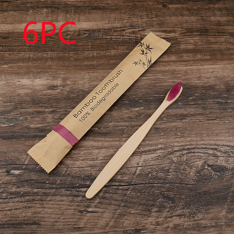 Bamboo toothbrush with packaging on a wooden surface, labeled as 6PC.