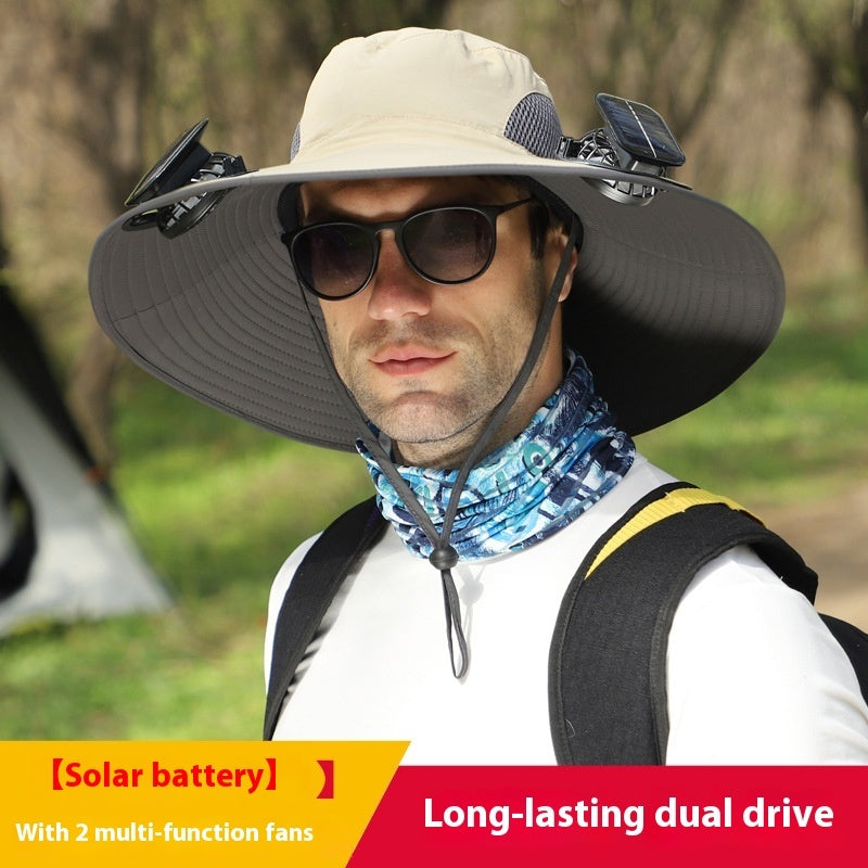 Man wearing a large sun hat with solar battery and fans, outdoors.
