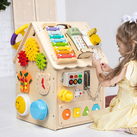 Child playing with a colorful wooden activity cube