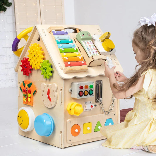 Child playing with a colorful wooden activity cube