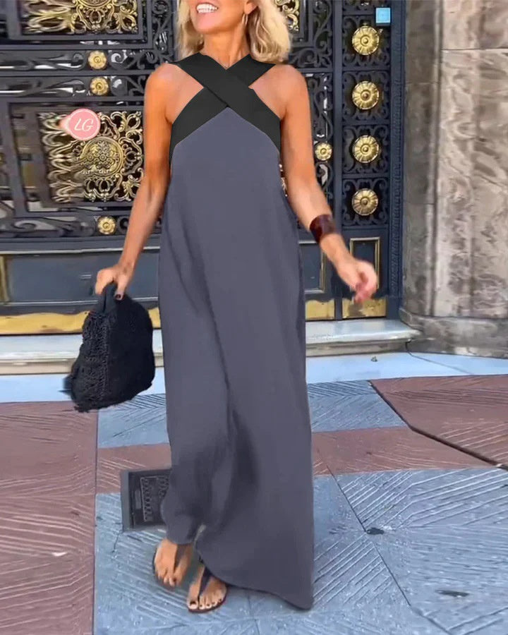 Woman wearing a black and gray dress standing in front of ornate doors.