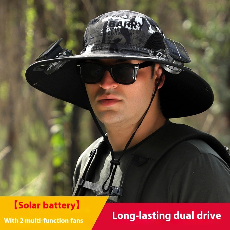 Person wearing a large black hat with solar battery and fans, standing in a forest.