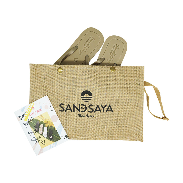 Pair of sandals in a jute bag with 'SANDSAYA' branding on a white background