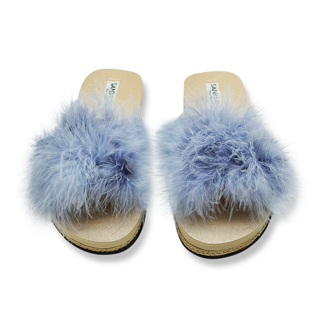 Pair of blue feathered sandals on a white background