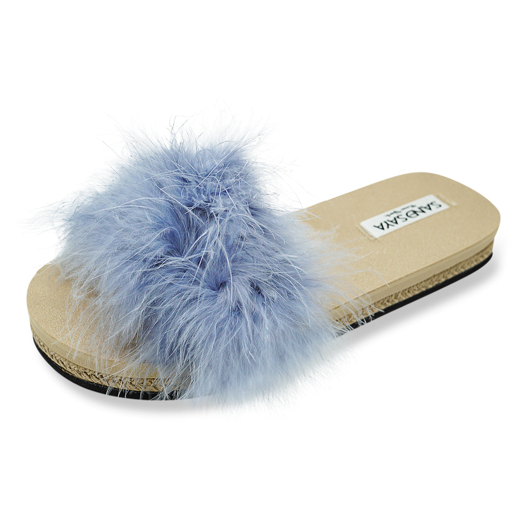 Blue fluffy slide sandal with a beige sole on a white background