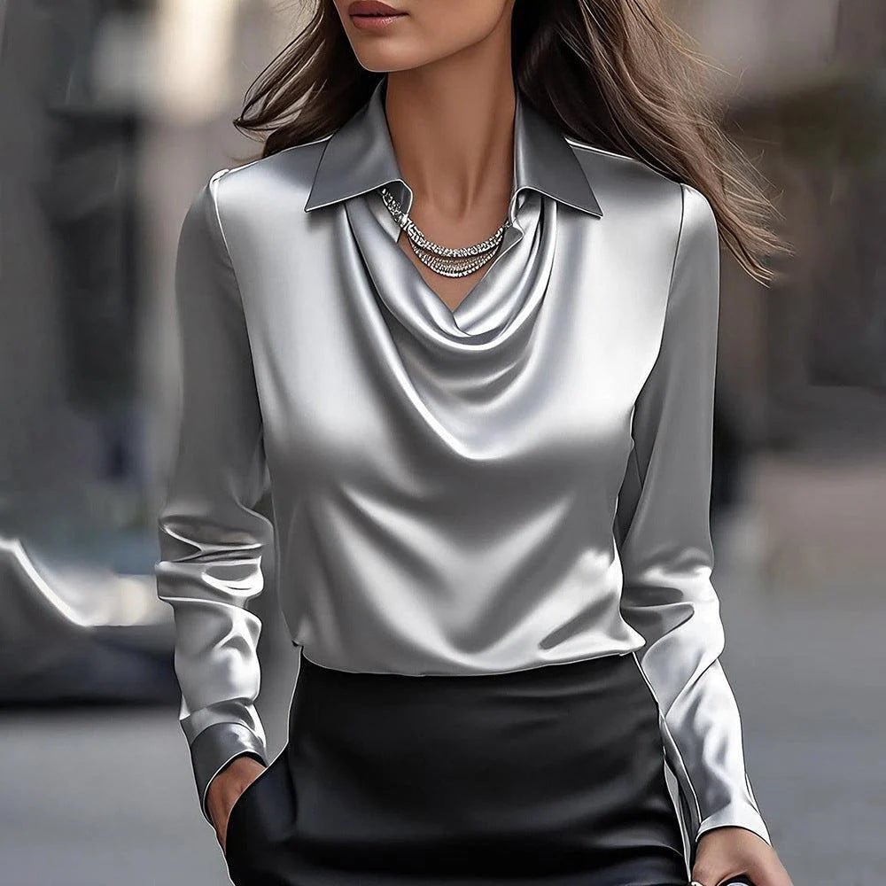 Woman wearing a silver blouse with a blurred background