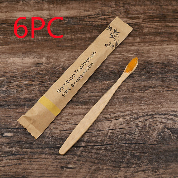 Bamboo toothbrush with packaging on a wooden surface, labeled as 6-pack.