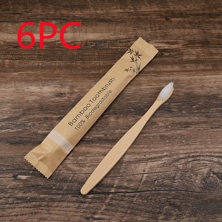 Bamboo toothbrush with packaging on a wooden surface, labeled as 6-pack.