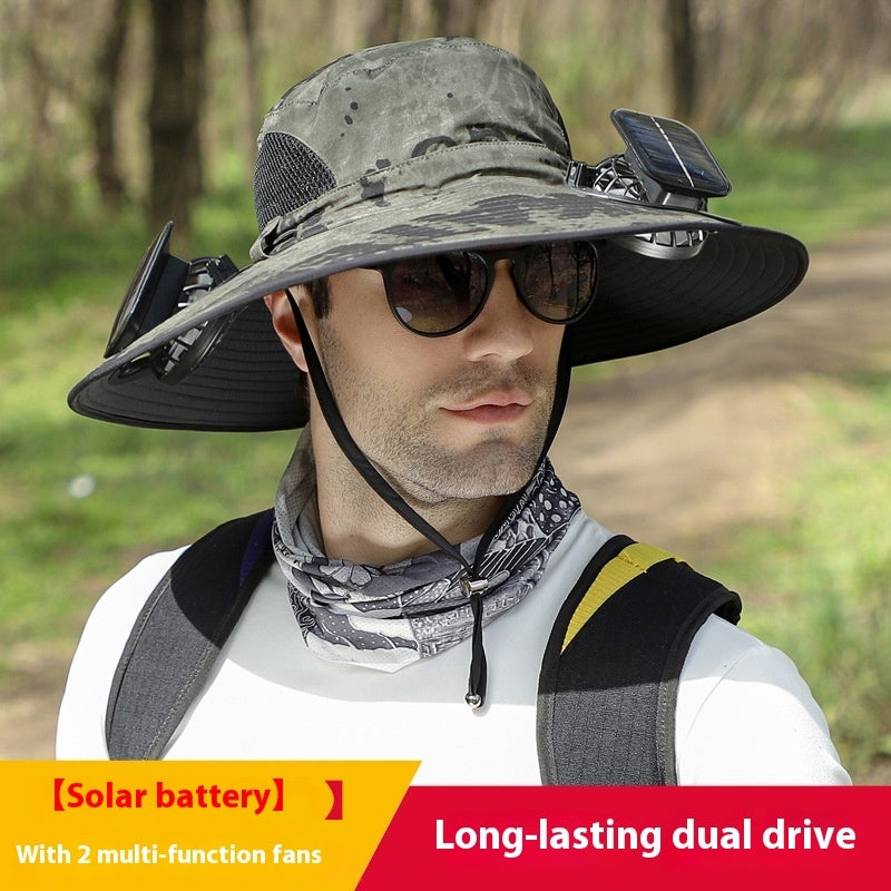 Person wearing a large sun hat with solar battery and fans, outdoors.