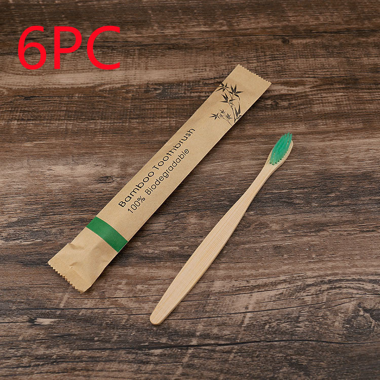 Bamboo toothbrush with packaging on a wooden surface, labeled as 6-pack.