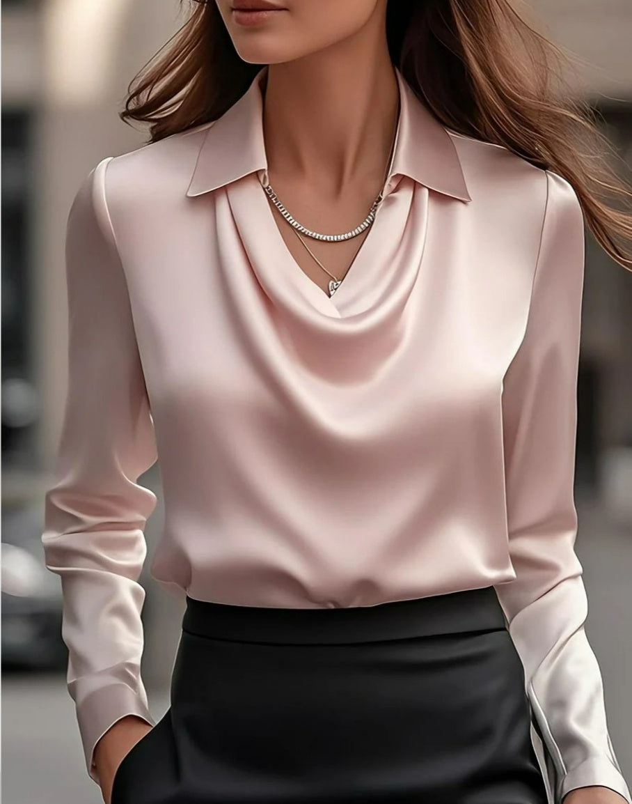 Woman wearing a light pink blouse with a blurred background