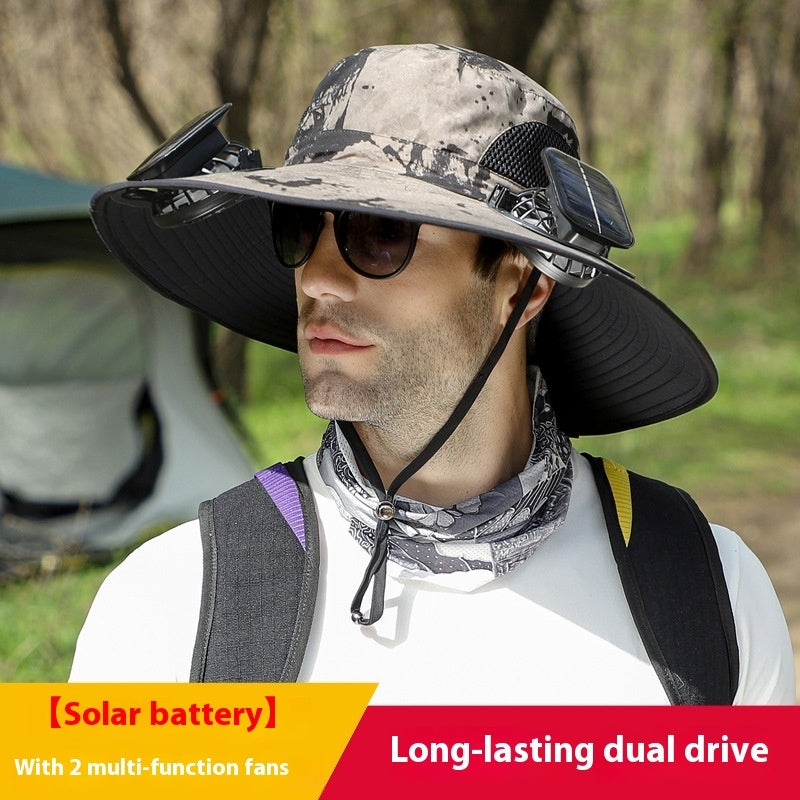 Man wearing a camouflage hat with solar battery and fans, standing outdoors.