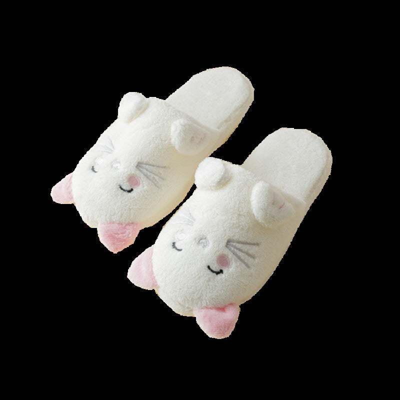 Pair of white plush slippers with cartoon face design on a black background