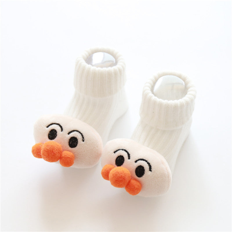 White baby socks with cartoon face design on a white background