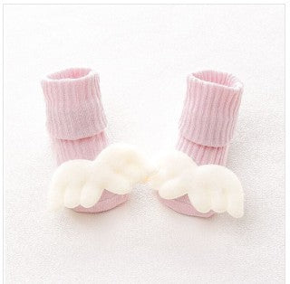 Pair of pink baby socks with white paw prints on a white background