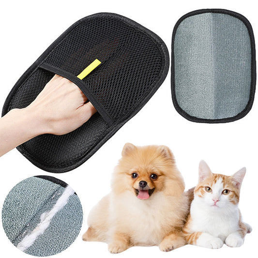 Black pet grooming glove with textured surface held by a hand, shown alongside a fluffy dog and a white-orange cat