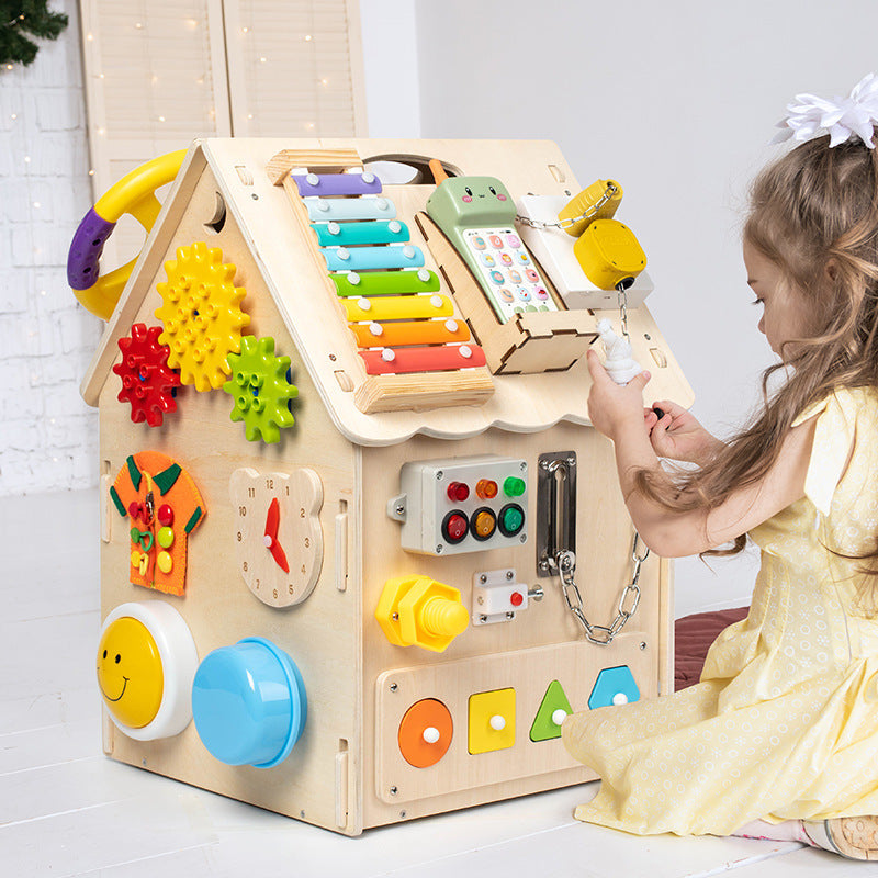 Child playing with a colorful wooden activity cube