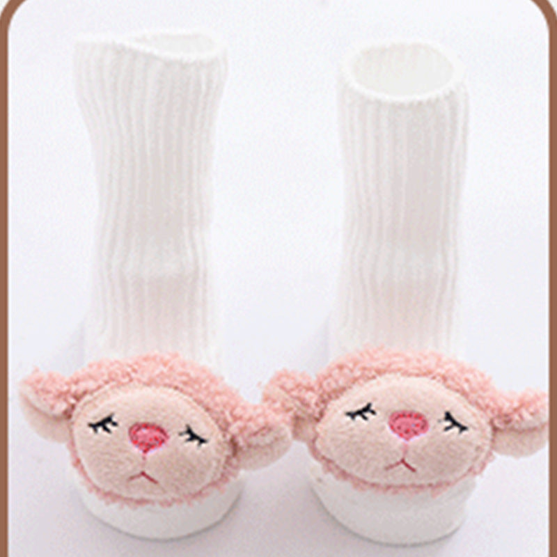 Pair of white socks with pink sheep faces on a light gray background