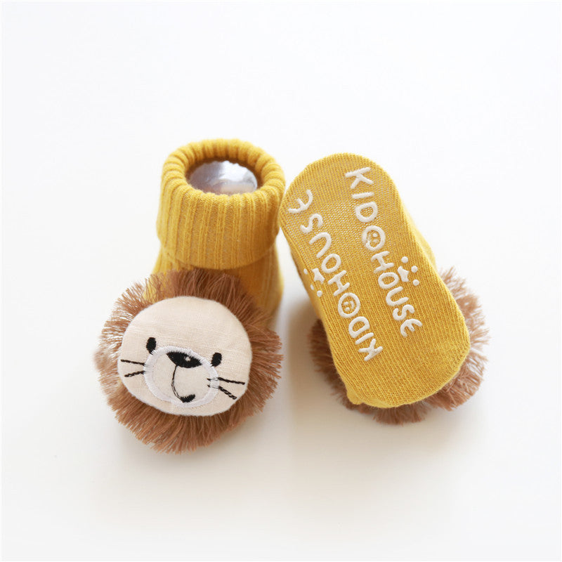 Yellow lion-themed baby booties with 'KIDOHOUSE' branding on a white background