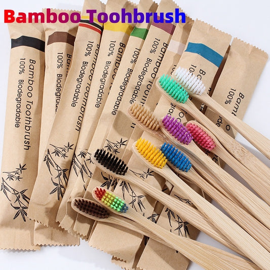 Set of eco-friendly bamboo toothbrushes with colorful soft bristles and individual kraft paper packaging, displayed on a white background