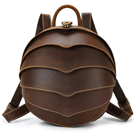 Vintage brown beetle-style leather backpack with curved shell design