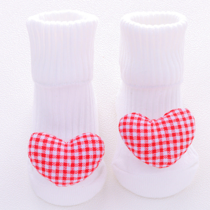White socks with red and white checkered hearts on a white background