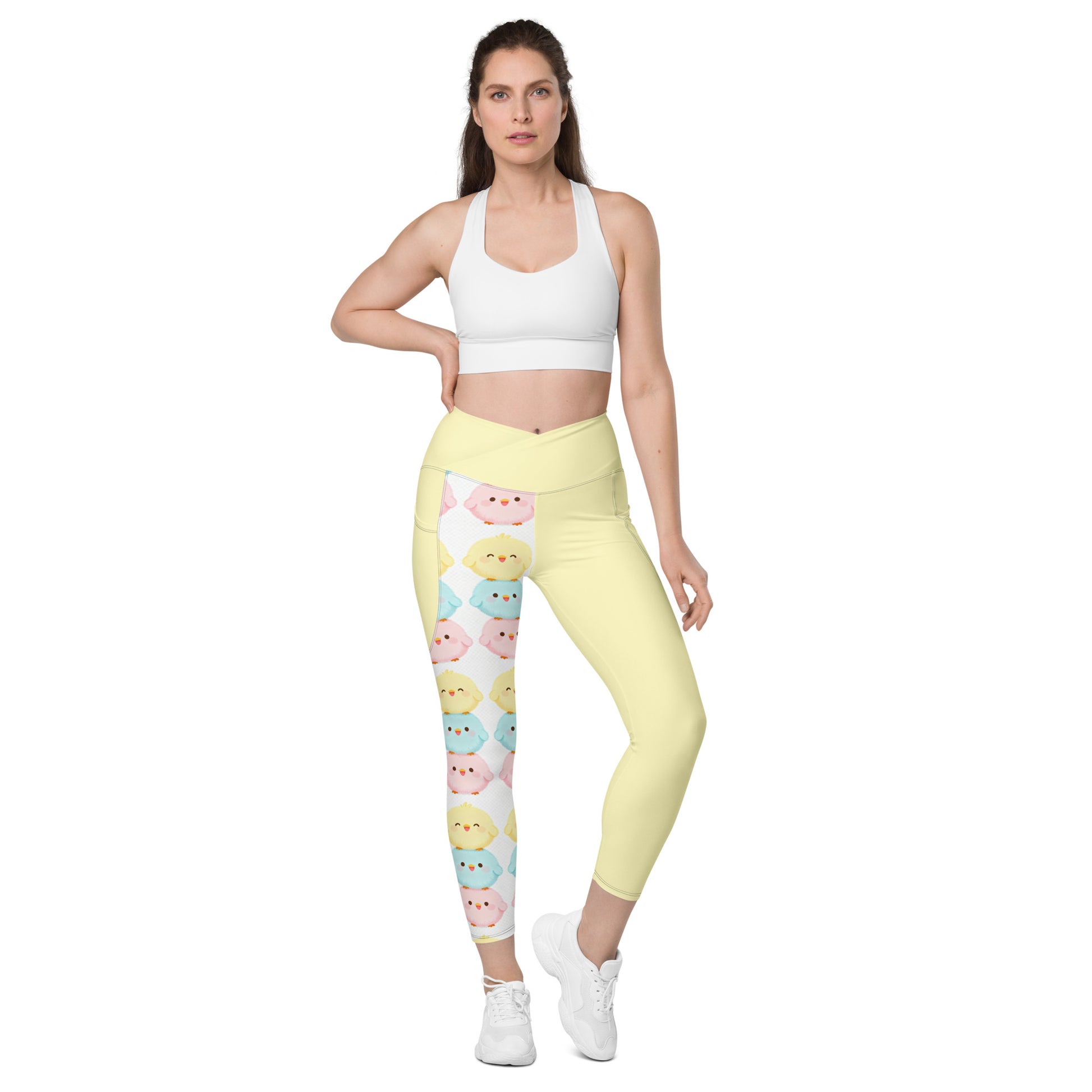Women's cute animal crossover leggings with pockets in pastel yellow featuring adorable kawaii characters - front view

