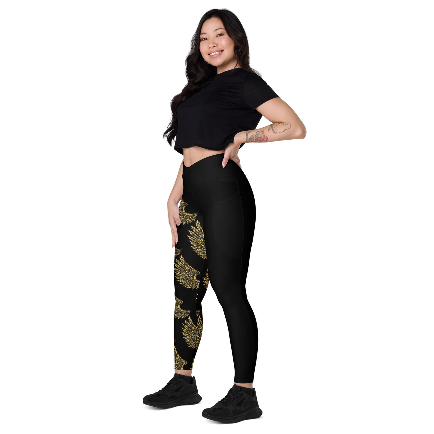 Front pose of women's crossover leggings with golden crane print and practical side pockets
