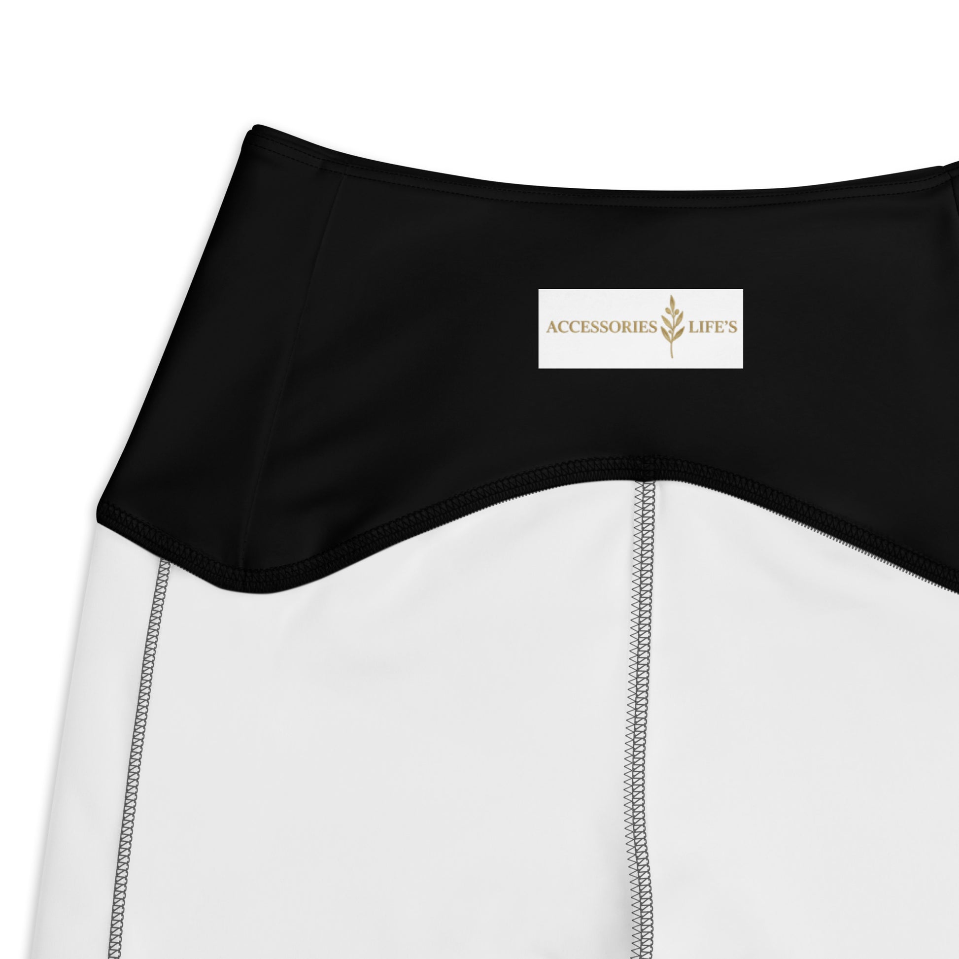 Close-up of AccessoriesLifes brand label on golden crane crossover leggings waistband

