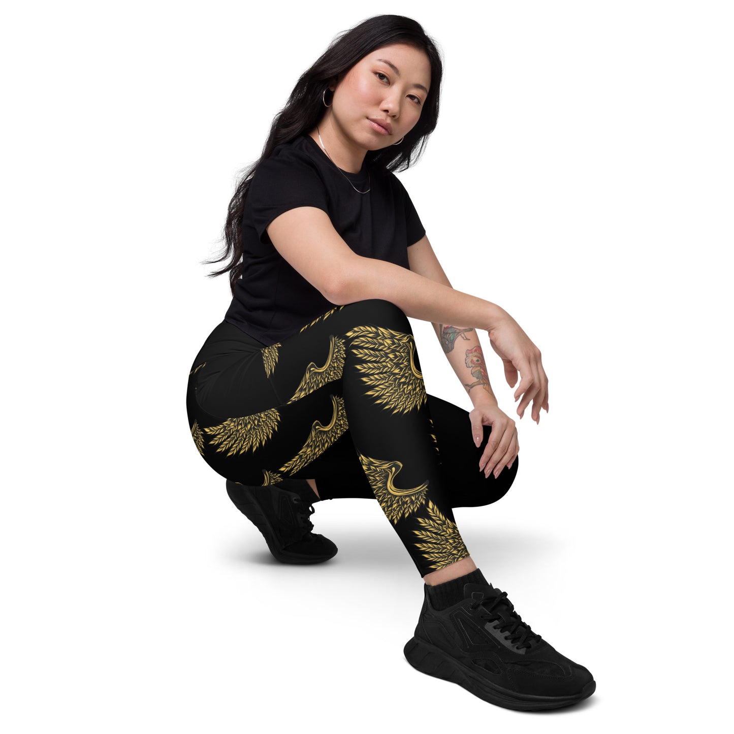 Women's golden crane crossover leggings with pockets featuring elegant Japanese-inspired design - front view with black sneakers
