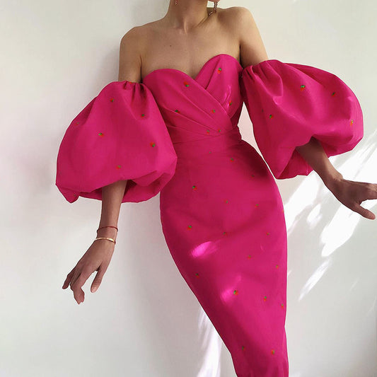 Pink strapless dress with puffed sleeves on a white background